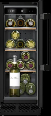 A wine cooler filled with wine bottles, with the door slightly ajar.