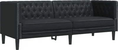 A black tufted sofa with silver stud accents on a white background.