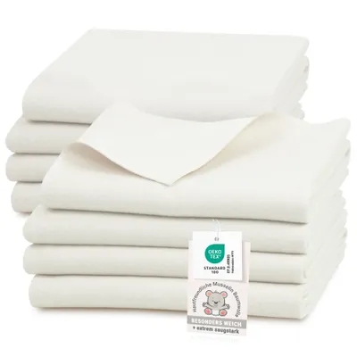 A stack of white muslin cloths with a tag attached.