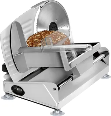 A silver electric food slicer with a loaf of bread on it, set against a white background.