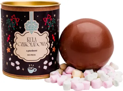 A chocolate ball with marshmallows next to a tin can.