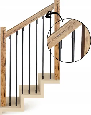 A close-up view of a wooden staircase railing with black metal balusters.