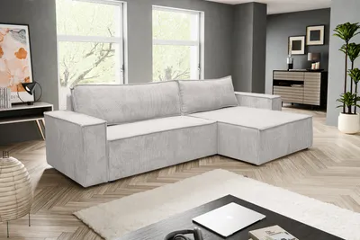 A modern living room with a sectional sofa, coffee table, and artwork.