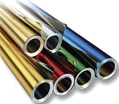 Several rolls of colored metallic foil are arranged diagonally.