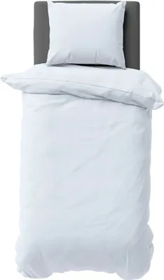 A white duvet and pillow set laid out on a bed with a grey headboard.
