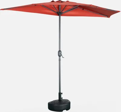 A red half umbrella with a gray pole and a black base, isolated on a white background.