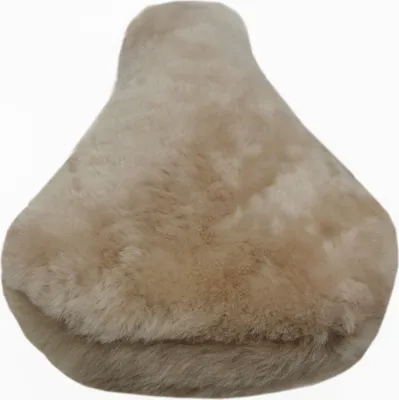 A close-up, studio shot of a beige sheepskin bicycle seat cover against a white background.