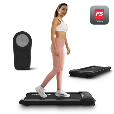 A woman walking on a treadmill with a remote control and an app logo.