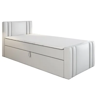 A white boxspring bed with a mattress and topper, shown from a side angle on a white background.