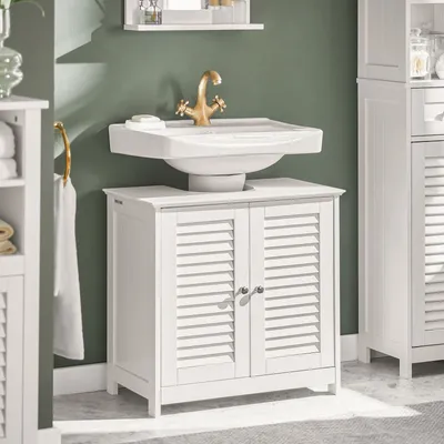 A bathroom vanity with a sink and faucet against a green wall.