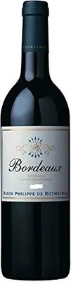A bottle of Bordeaux wine with its label.
