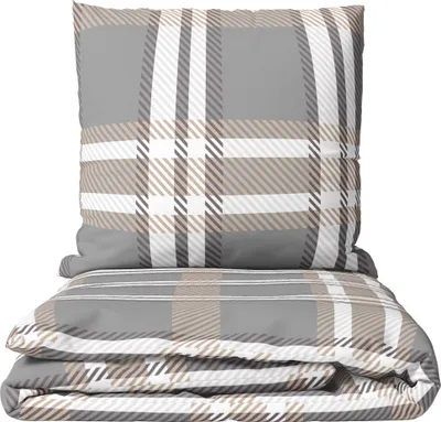 A folded duvet and a pillow with a plaid pattern.