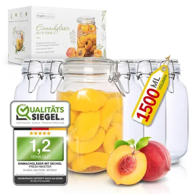 A set of glass jars filled with peaches, along with a box and quality seals.
