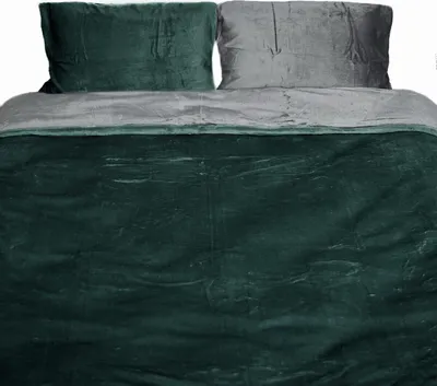 A bed with pillows and a duvet cover.