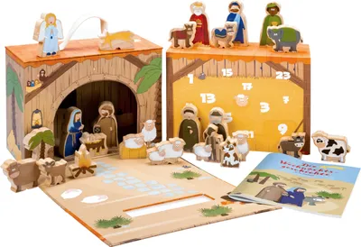 A wooden nativity scene advent calendar with figures and a booklet.