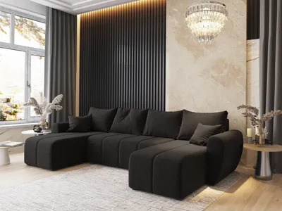 A modern living room with a large sectional sofa, decorative wall paneling, and a chandelier.