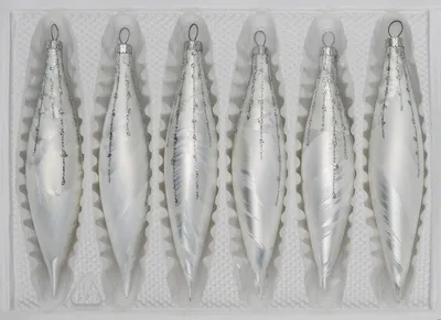 A set of six glass icicle ornaments in a white molded plastic tray.
