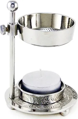 A silver metal incense burner with a tea light candle underneath.