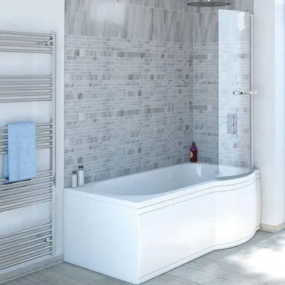 A modern bathroom with a white bathtub, a curved glass shower screen, and a chrome towel rack.