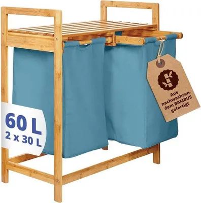 A bamboo laundry basket with two blue fabric bags.