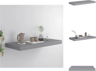 A gray floating shelf mounted on a white wall, with decorative items placed on it.