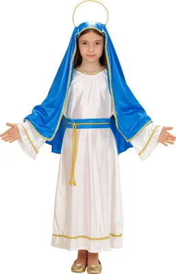 A young girl dressed as the Virgin Mary stands with her arms outstretched.