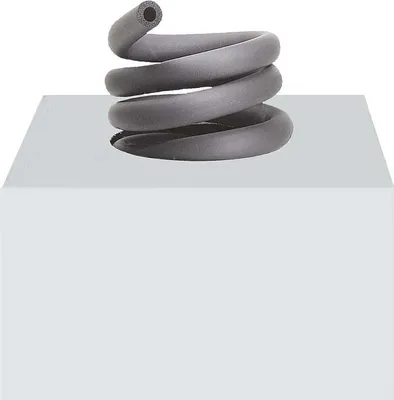 A coiled gray pipe insulation is shown resting on a white cube.