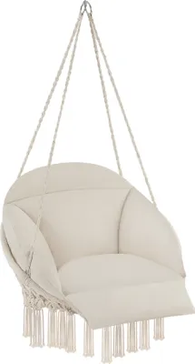 A cream-colored hanging chair with fringe details, suspended by ropes.