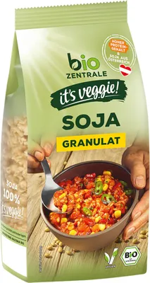 A bag of soy granules with a bowl of prepared food.