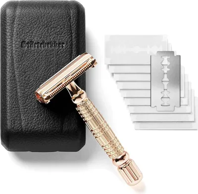 A rose gold safety razor and a set of replacement blades are displayed next to a black leather case.