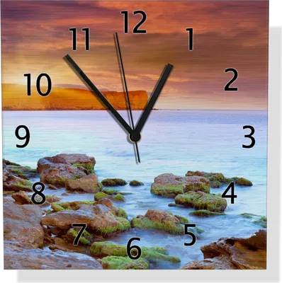 Produktbild von Wallario Design Wanduhr Sonnenaufgang am Meer mit Landzunge und Felsen im Wasser aus Aluverbund, Größe 30 x 30 cm