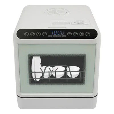 A white compact dishwasher with dishes inside, shown from the front.