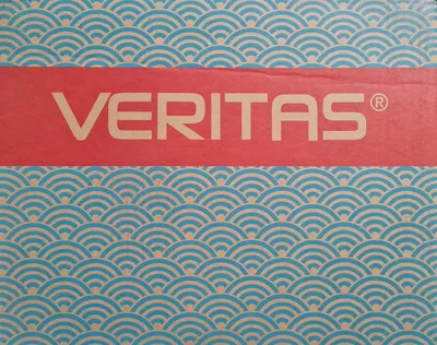 A close-up of a red band with the word VERITAS in white text, set against a background of blue and tan wave-like patterns.