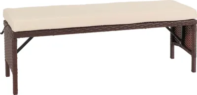 A brown rattan bench with a cream cushion, shown against a white background.
