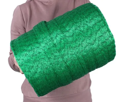A person holding a rolled-up green net.