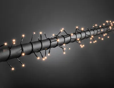 Produktbild von Konstsmide - Microlight Lichterkette, verschweißt, 120 klare Birnen, 24V Außentrafo, schwarzes Kabel ; 2016-000