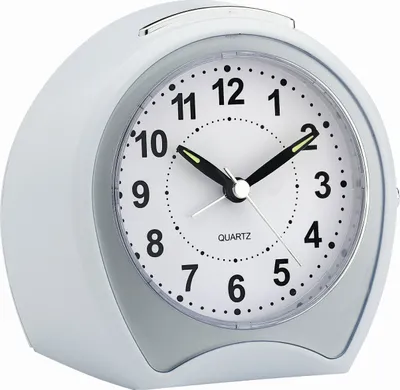 A white alarm clock with a silver trim is shown against a white background.