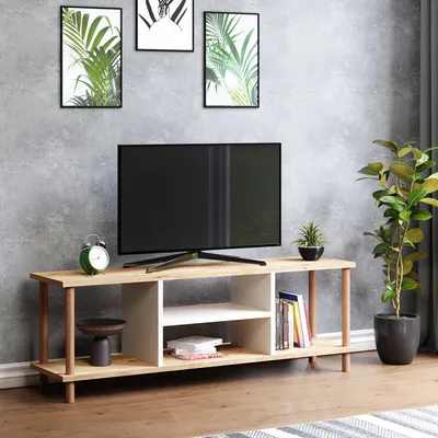 A TV stand with a television and decorative items in a living room setting.