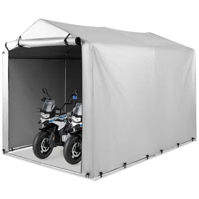 Two motorcycles are parked inside a silver-grey tent-like garage structure.
