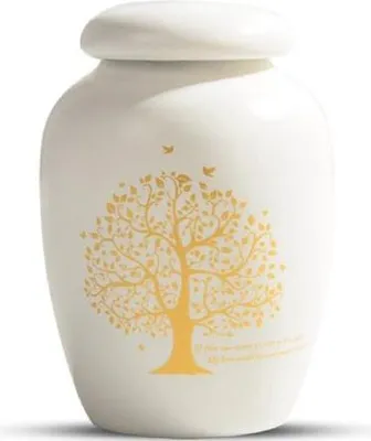 A white urn with a gold tree design and two birds.