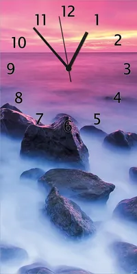 Produktbild von Wallario Design Wanduhr bedruckt, Größe 30 x 60 cm, Motiv: Felsen im Meer bei Sonnenuntergang