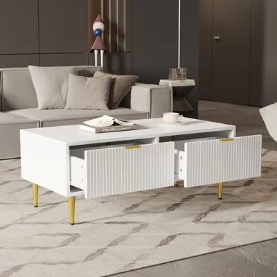 A modern living room scene with a white coffee table in the foreground, a sofa and decorative items in the background.