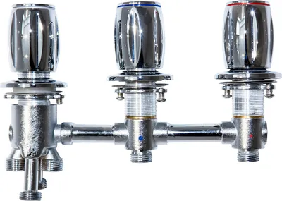 A chrome-plated faucet assembly with three control knobs and a diverter.