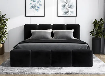 A black upholstered bed with a headboard and matching ottomans in a bedroom setting.