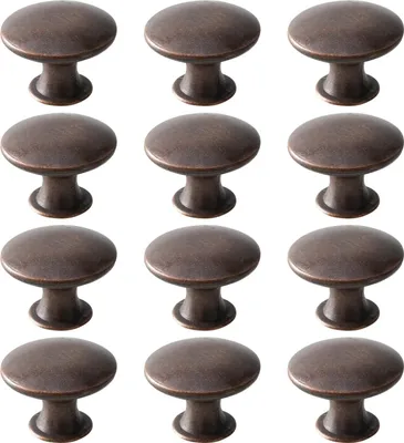 A set of 12 vintage-style cabinet knobs in a red-bronze finish, arranged in a grid.