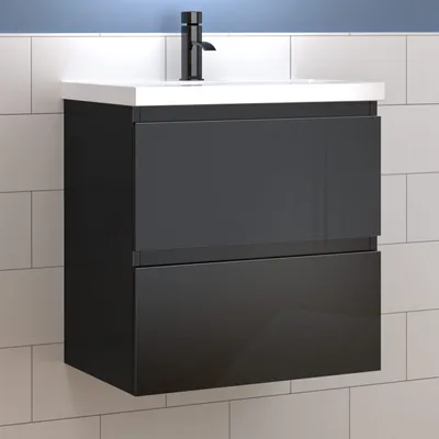 A modern black bathroom vanity with a white countertop and sink, mounted on a tiled wall.