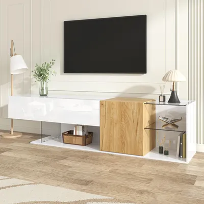 A modern living room setup featuring a TV stand with a television mounted on the wall.