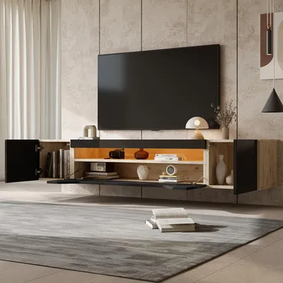 A modern living room with a wall-mounted TV cabinet and a large television.