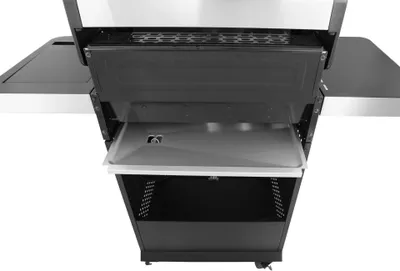A close-up view of the interior and lower section of a gas grill.