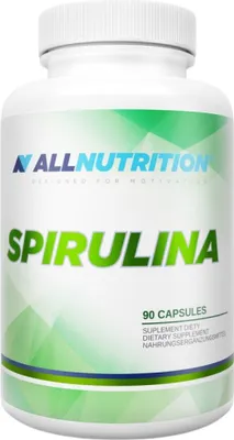 A white bottle of spirulina capsules with green and blue branding.